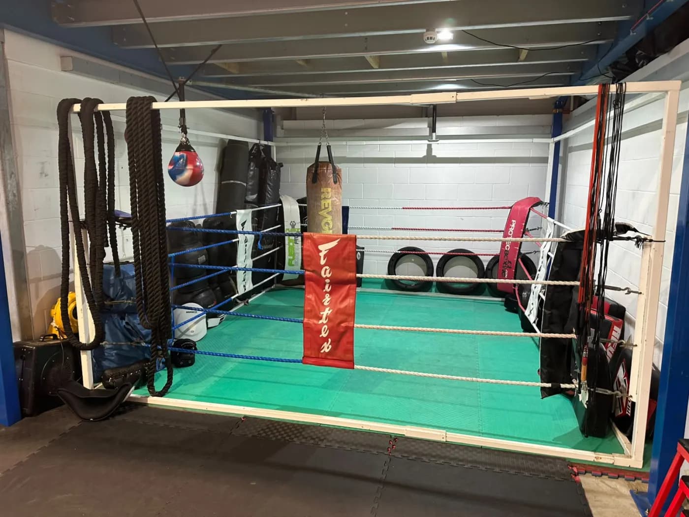 Sparring ring with rope-work station and conditioning tyres